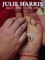 Julie's hands, folded in prayer, caress her 